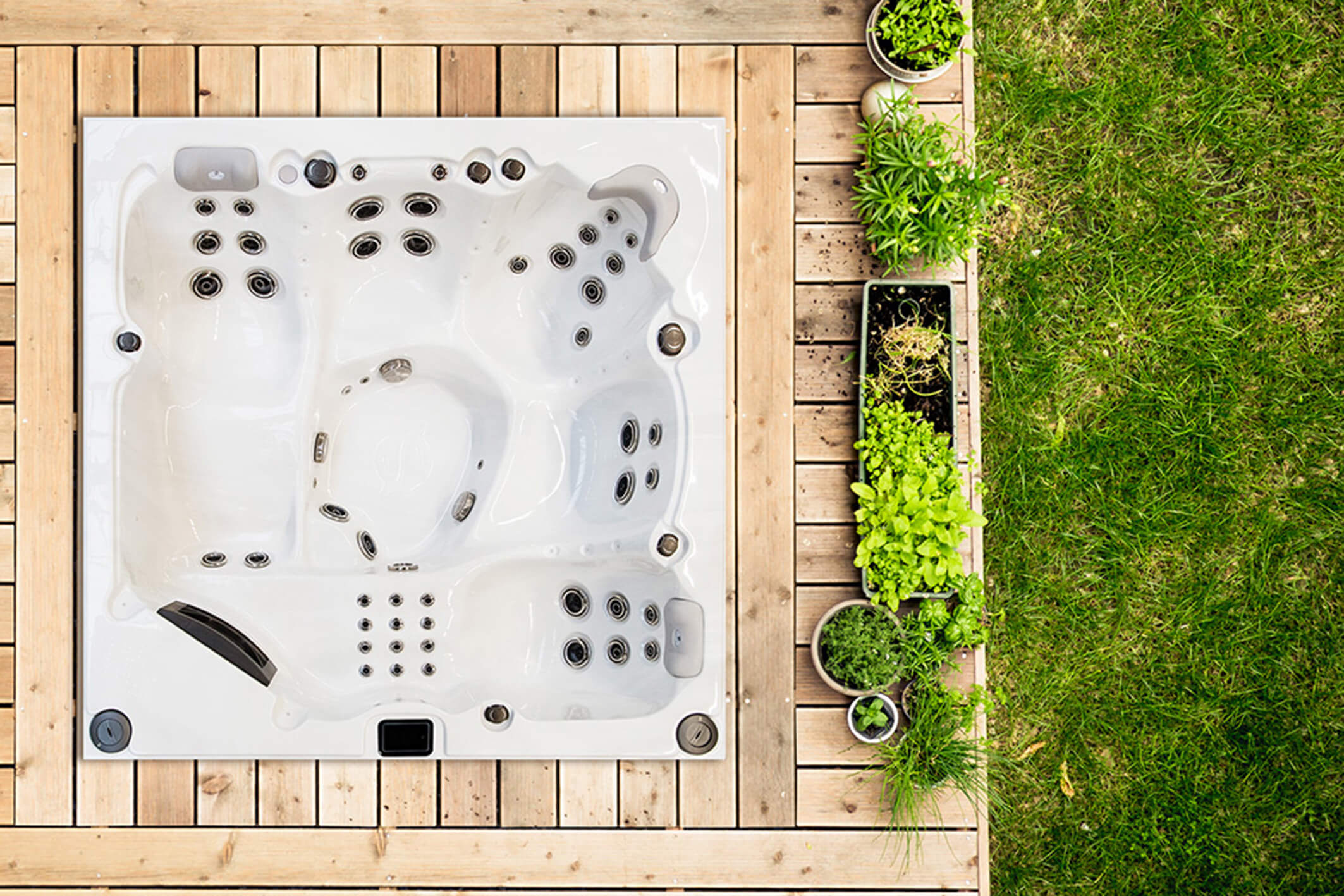 a wooden patio with flowerpots and a piece of lawn, viewed from above. this photo was taken during the "berlin istockalypse" photo event in june 2012.